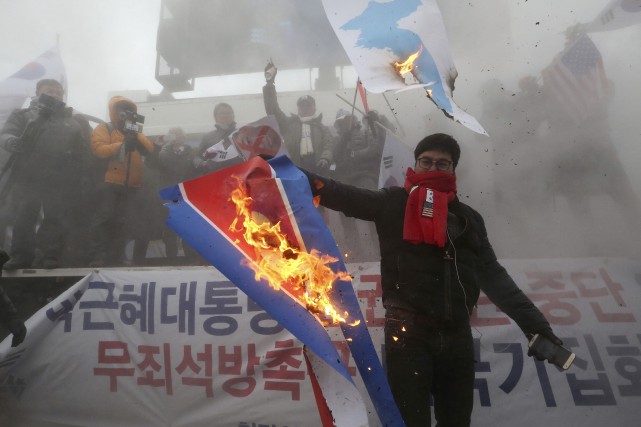 Des manifestants brûlent un drapeau nord-coréen à Séoul